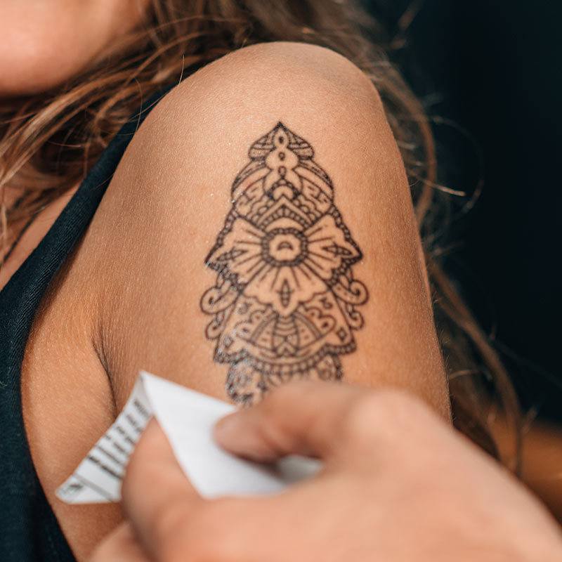 a close up of a person holding a tattoo
